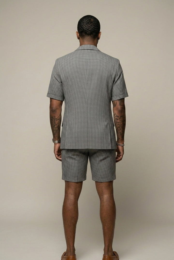 Matching men's black check blazer and shorts set, a tailored two-piece outfit for modern smart casual events.