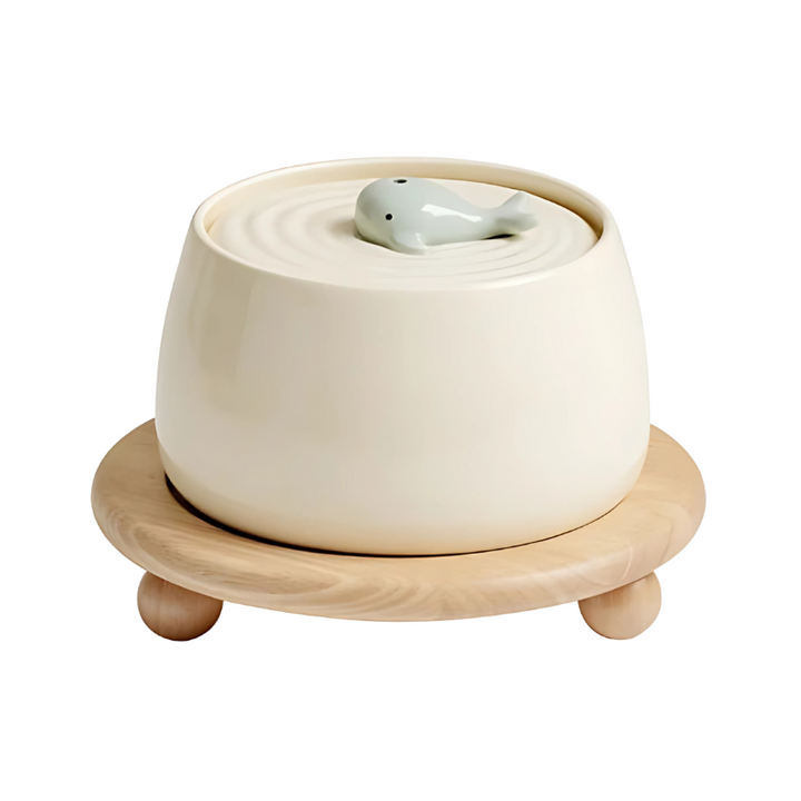 Green ceramic pet waterer with quiet pump, providing continuous filtered water, promoting healthy drinking for dogs & cats.