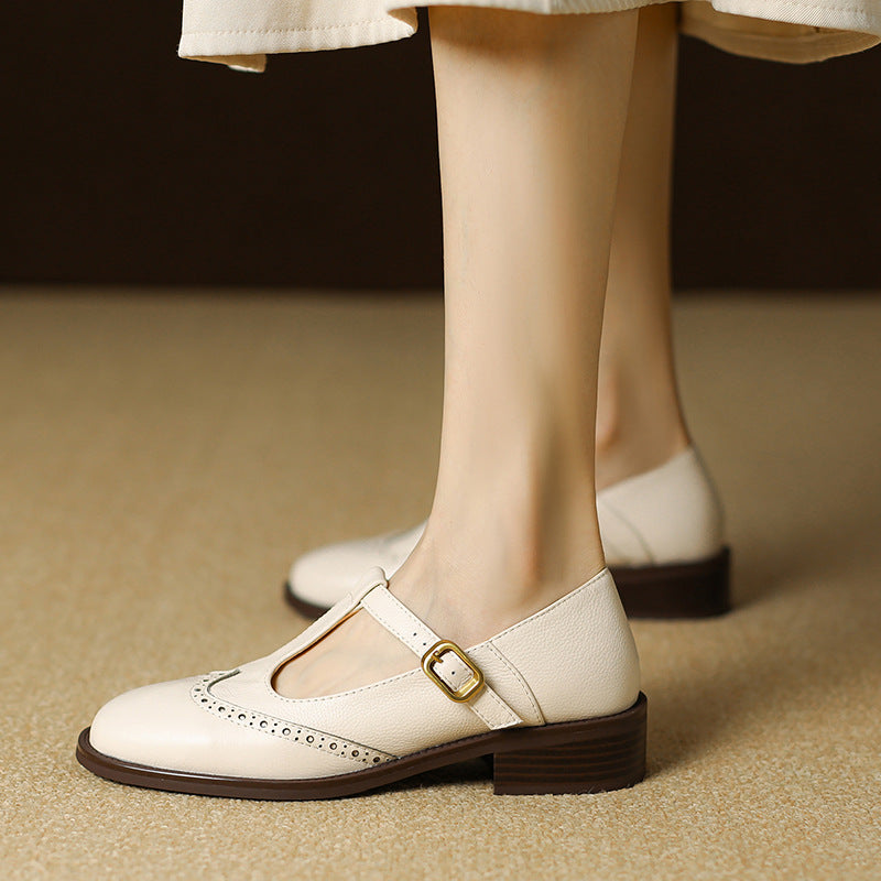 Beige leather T-Bar Mary Janes for women with classic brogue details and comfortable block heel.