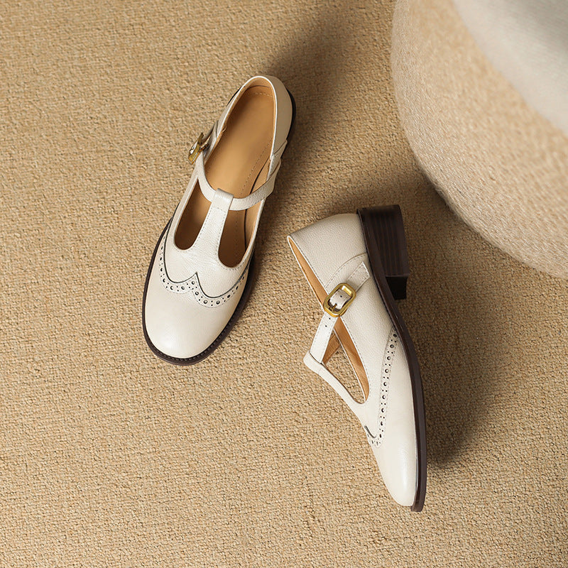 Women's black leather T-Bar Mary Jane shoes featuring elegant brogue accents and a sturdy block heel.