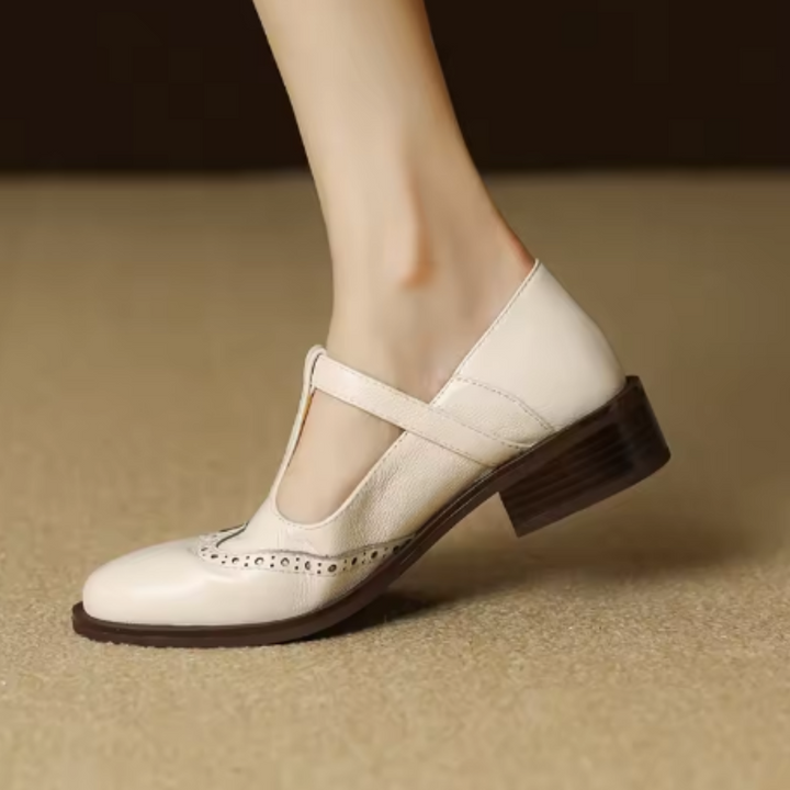 Brown vintage style T-Bar Mary Janes for women, detailed with traditional brogue perforations.