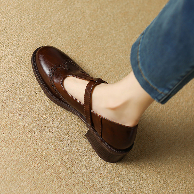 Women's classic T-Bar Mary Janes in brown, complete with intricate brogue work on the toe.