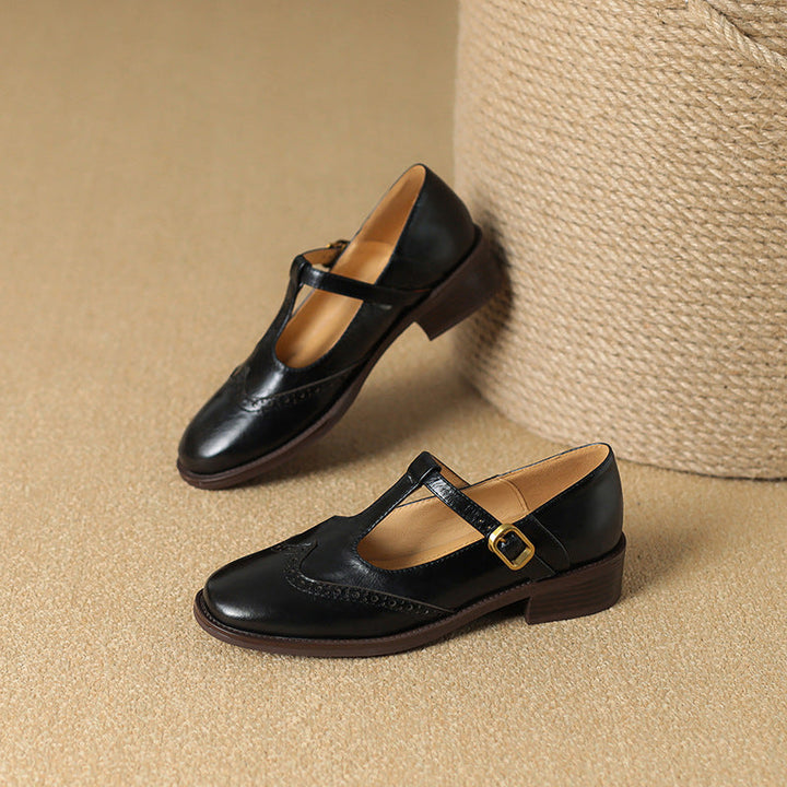 Brown leather women's T-Bar Mary Jane shoes, featuring stylish brogue details and a mid-height block heel.