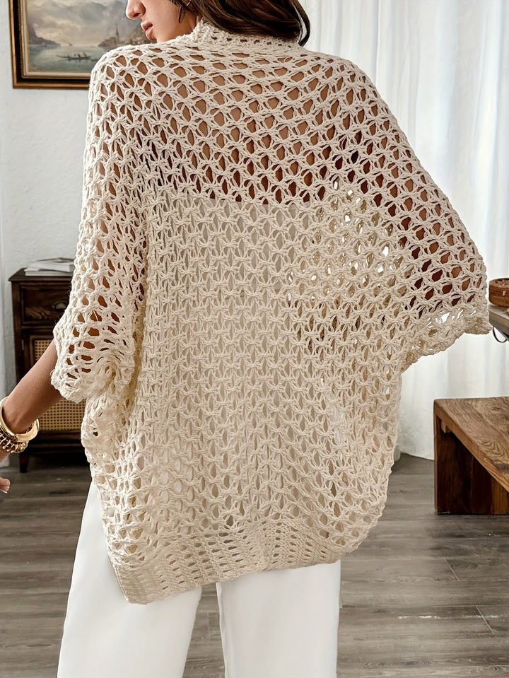 Close-up of a women's beige knit cardigan, featuring an elegant open front and draped design