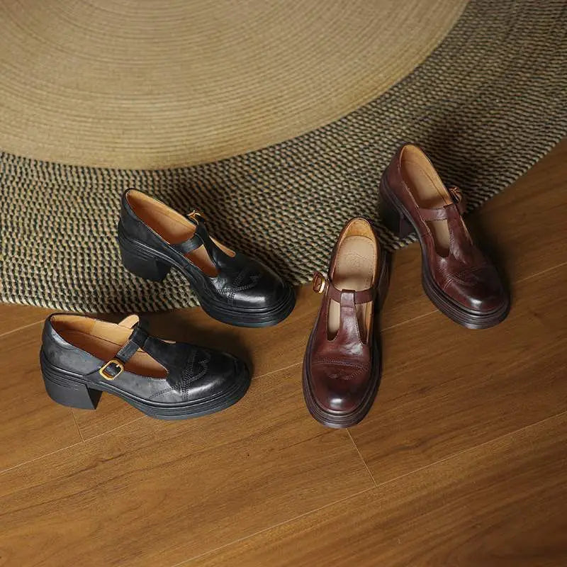 Close-up of a women's black leather T-strap shoe, highlighting the block heel and strap detail.