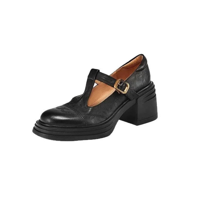Women's comfortable black leather T-strap block heel shoes, showcasing the timeless design.