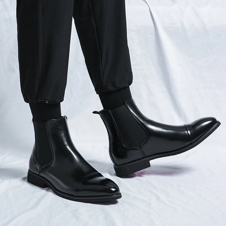 Black men's classic slip-on Chelsea boots with cap toe design, elegant and comfortable ankle footwear.