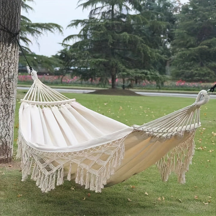Relaxing double cotton bohemian hammock with decorative tassels. Ideal garden furniture or patio accessory.