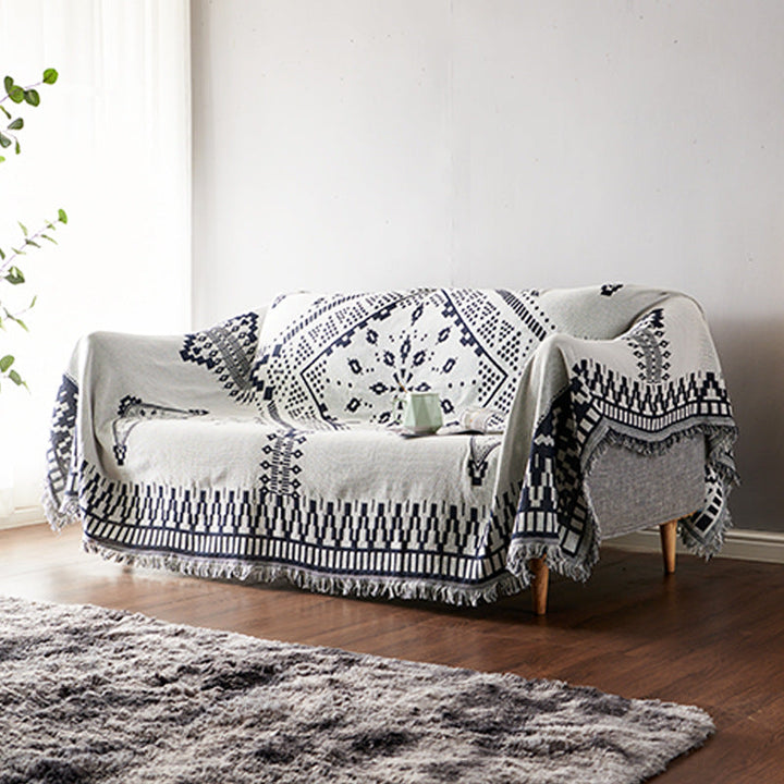 Bohemian fringed knitted blanket, a cozy and stylish home accent.