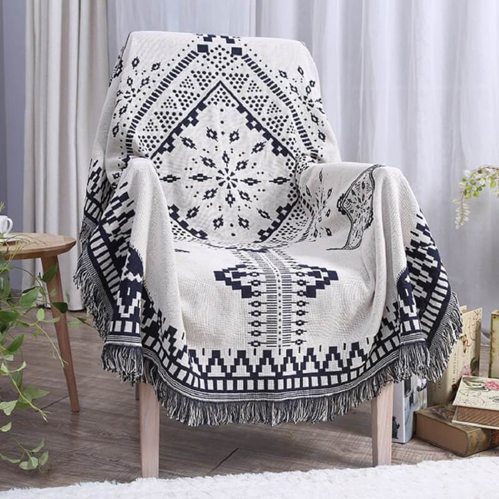 Soft cotton blend bohemian throw blanket, knitted with elegant tassels.