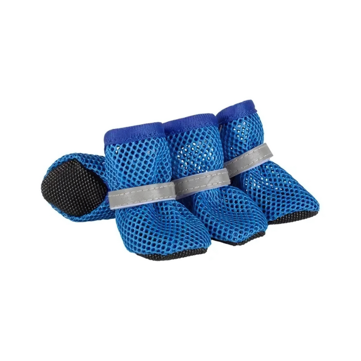 Dog walking outdoors wearing reflective, breathable mesh paw protection shoes for all-terrain comfort and safety.