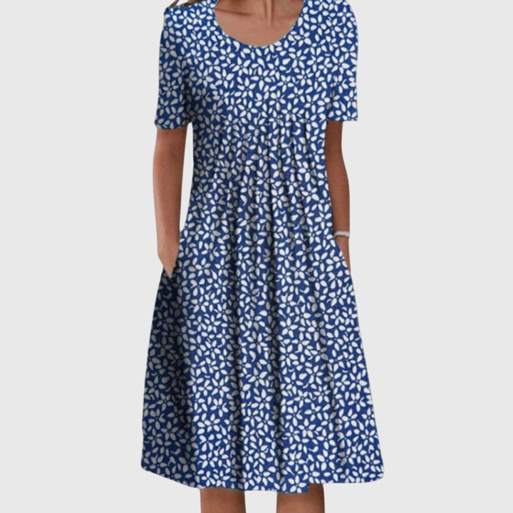 Versatile blue floral women's dress with a round neck, ideal for spring fashion and comfortable daily wear.