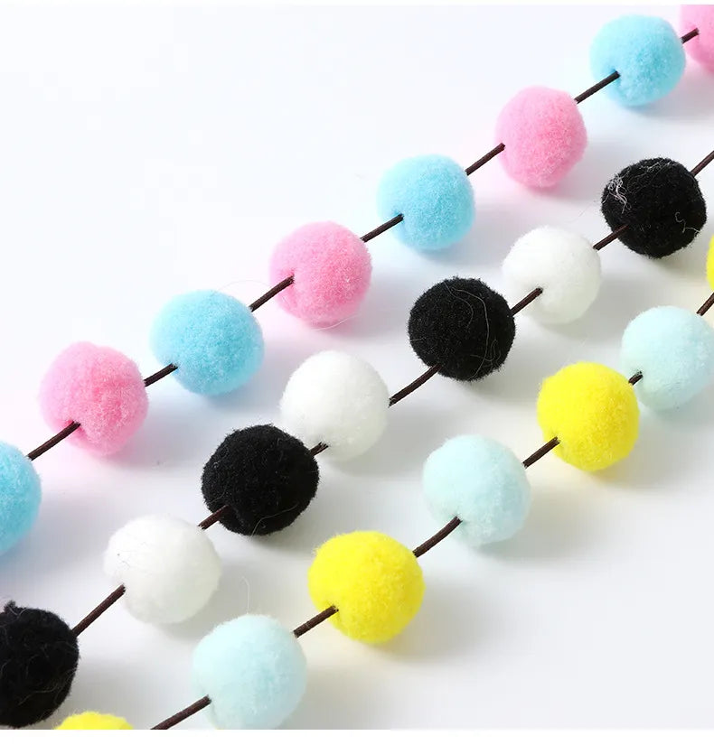 Durable cat enrichment toy rod featuring vivid feathers and soft pom poms for active play.