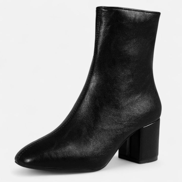Close-up of stylish women's ankle boots, featuring a chic block heel and quality material for everyday comfort.