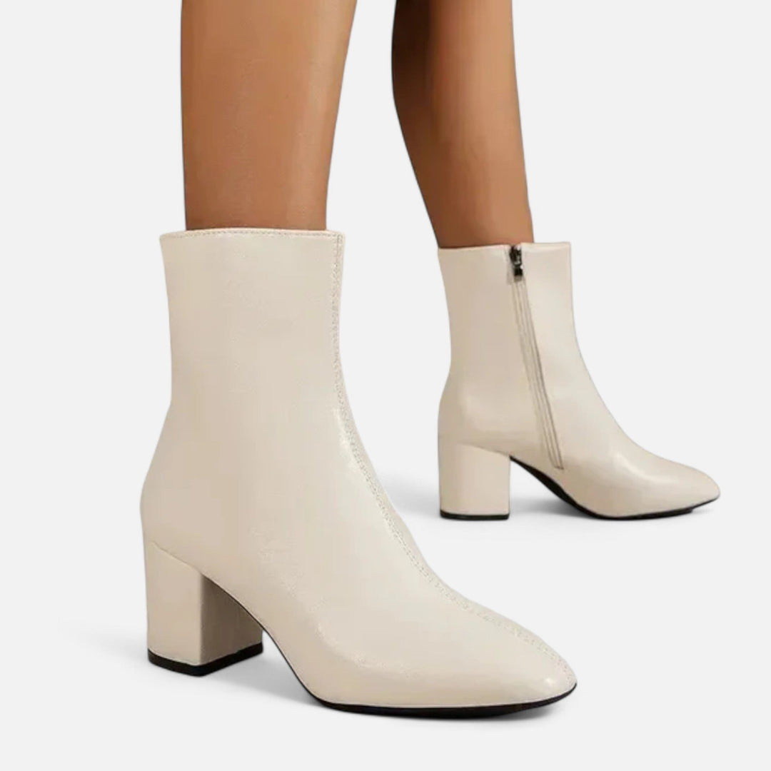 Side profile of comfortable women's ankle boots with a sturdy block heel, perfect for chic fall and winter outfits.