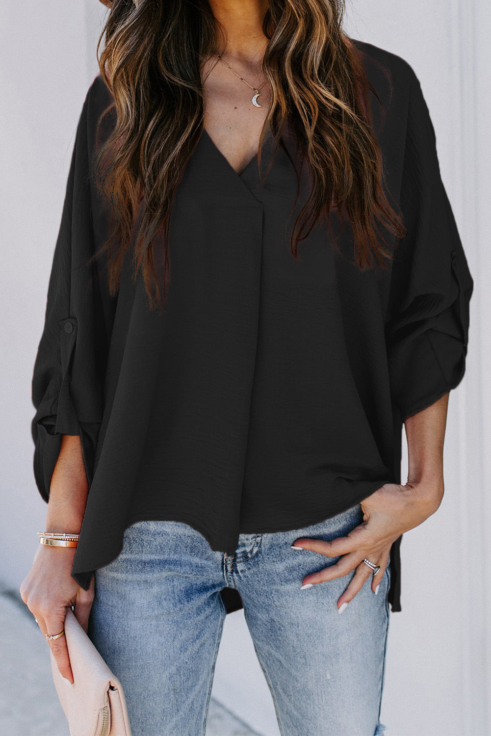 Elegant women's V-neck blouse with a relaxed fit. Ideal casual top for spring fashion and comfortable summer wear.