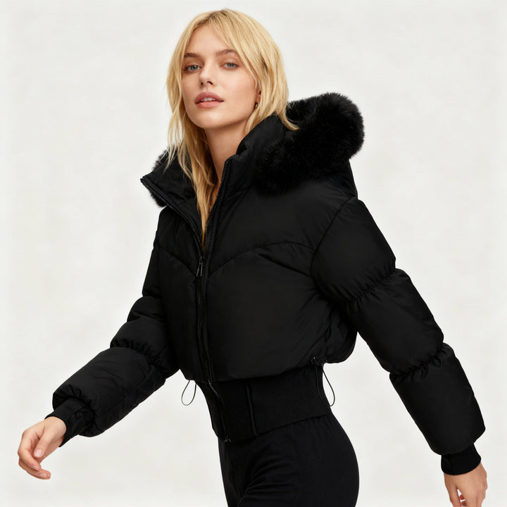 Chic women's cropped winter jacket, warm outerwear with stylish faux fur hood for trendy cold weather fashion.