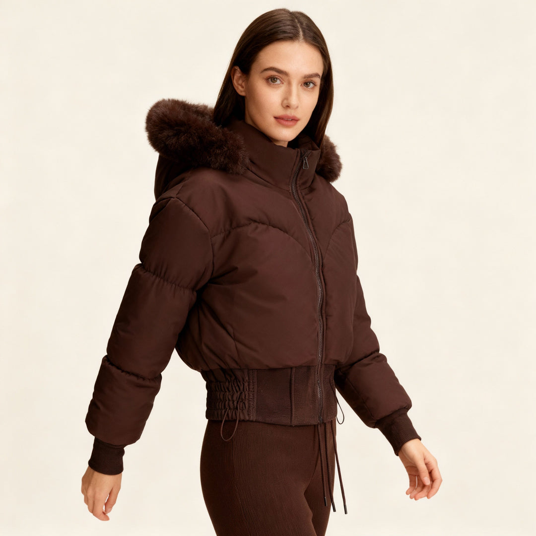 Modern women's cropped winter jacket with a soft faux fur hood, providing a warm and stylish look for winter.