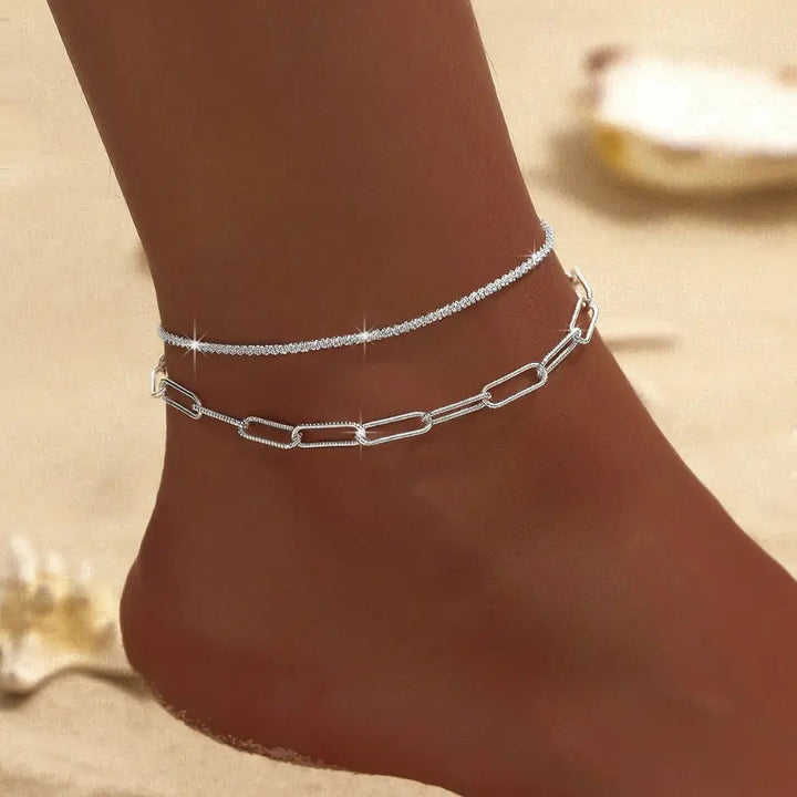 Stylish women's double silver & gold ankle bracelet, a delicate and elegant fashion gift accessory.