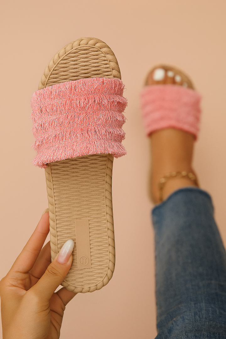 Stylish women's fringe slide sandals. Trendy summer flip-flops with decorative fringe, great for casual beach fashion.