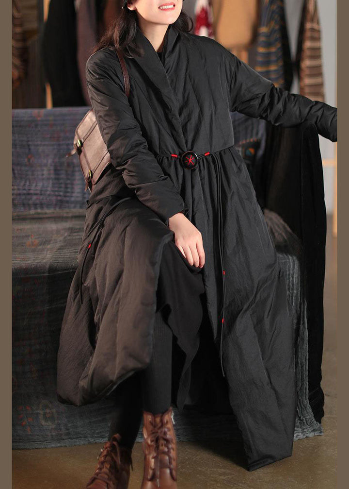 Fashionable women's black winter coat. High collar, button front, loose fit. Cozy & chic outerwear for cold weather.