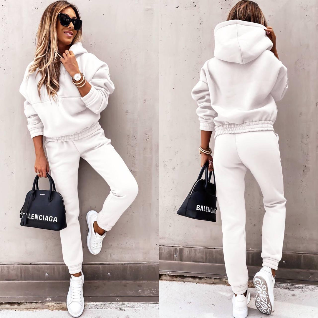 Stylish woman walking in a comfortable activewear grey sweatshirt and jogger set, perfect for casual outings.
