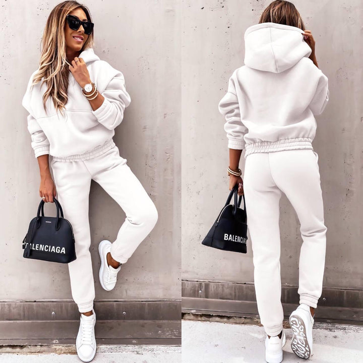 Stylish woman walking in a comfortable activewear grey sweatshirt and jogger set, perfect for casual outings.