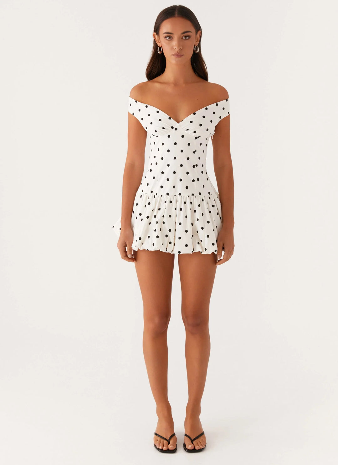 Trendy women's off-shoulder polka dot peplum mini dress, a chic choice for any casual or party event.