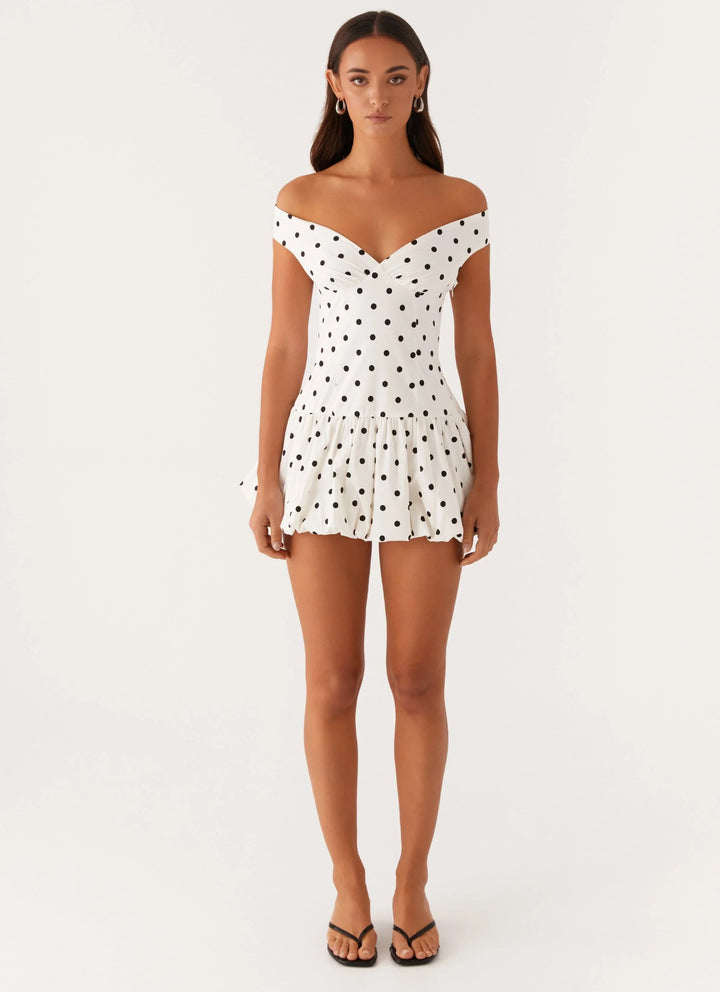 Trendy women's off-shoulder polka dot peplum mini dress, a chic choice for any casual or party event.