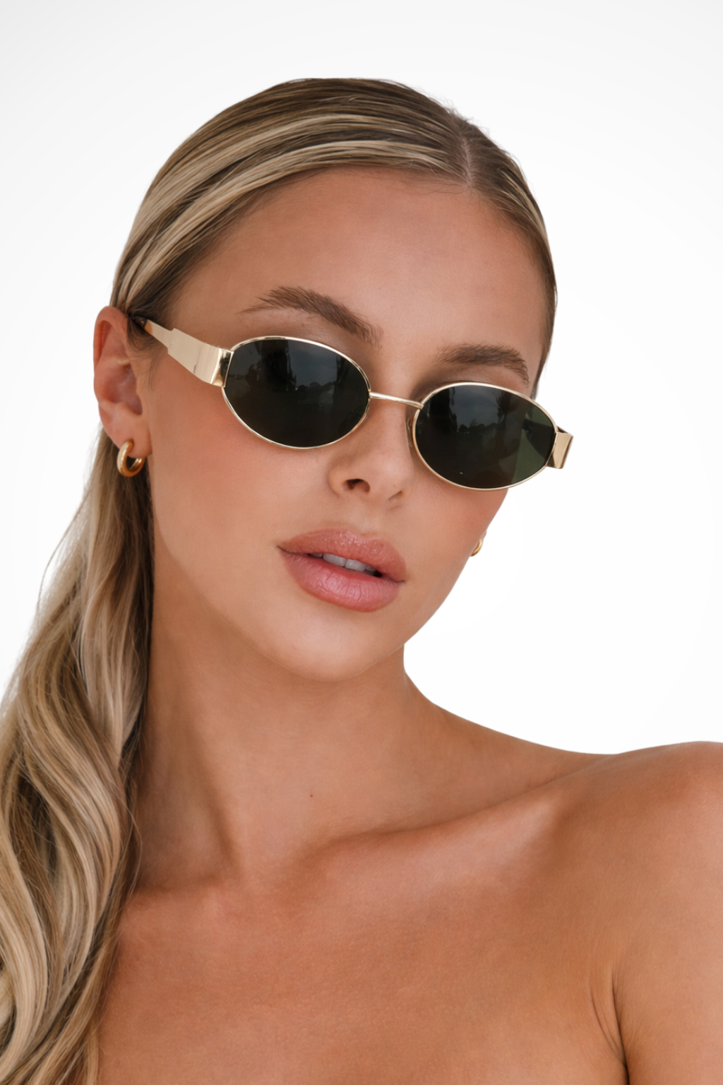 Chic women's oval metal frame sunglasses with tinted lenses. Fashionable & protective minimalist eyewear.