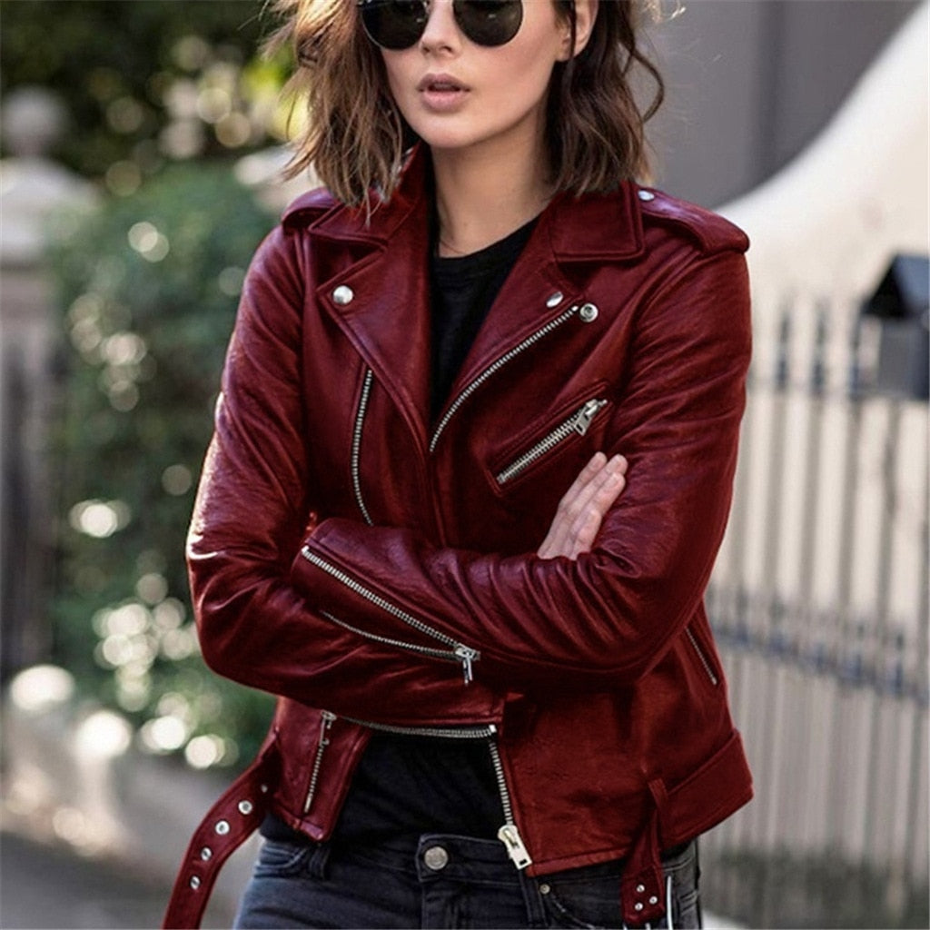 Fashionable women's faux leather jacket in vibrant color with zipper details and pockets, offering a chic look.