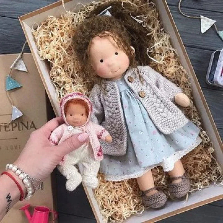 Children's handmade Waldorf doll, soft cotton toy, with a matching fabric box.