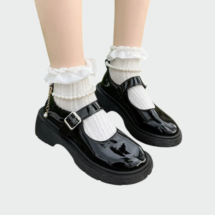 Classic black Mary Jane flats for women with an adjustable strap & glossy finish, perfect for everyday wear