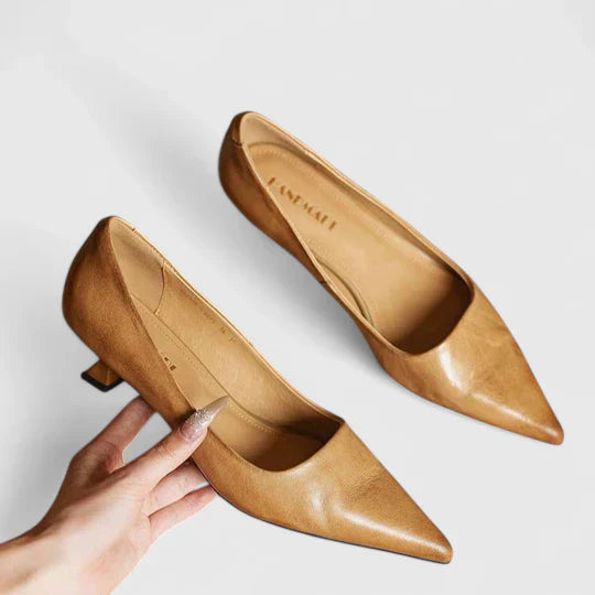 Detailed view of the low heel on a women's classic black pointed toe pump