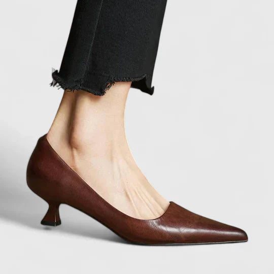 Women's classic navy blue pointed toe pumps with a low heel, ideal for formal attire