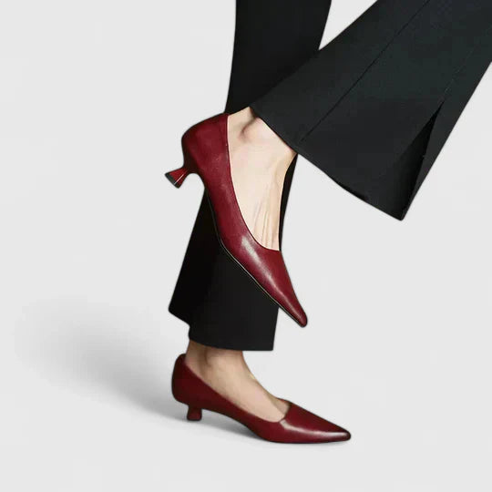 Close-up of a women's classic pointed toe pump, highlighting the low heel and smooth finish