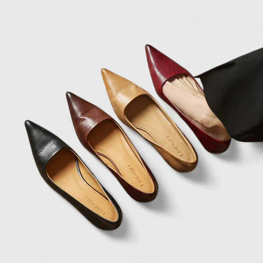 Side profile of a women's black pointed toe low heel pump, showcasing classic design