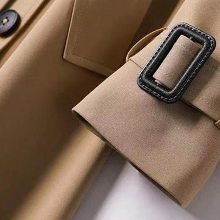 Green women's outerwear, a stylish belted trench coat for colder weather.