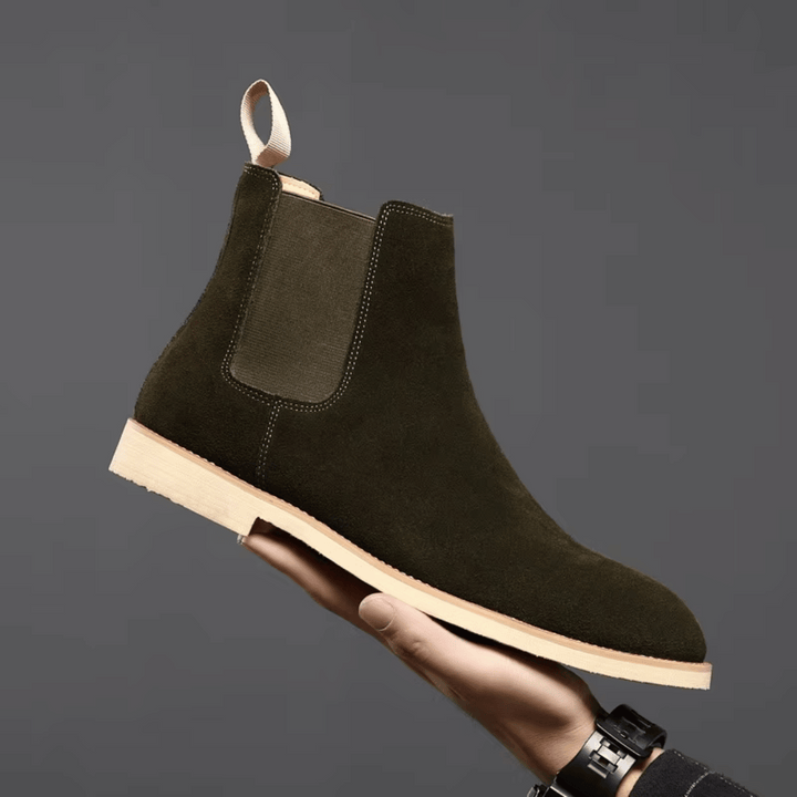 Dark brown leather men's Chelsea boots with elastic sides, suitable for casual footwear.