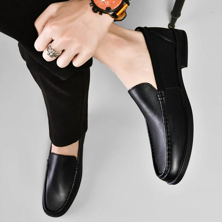 Front view of men's classic slip-on loafers, refined & comfortable versatile men's footwear.