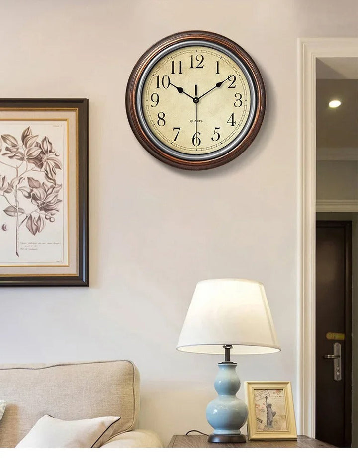 Classic round wall clock with brown frame, white face, and black Roman numerals for home or office decor