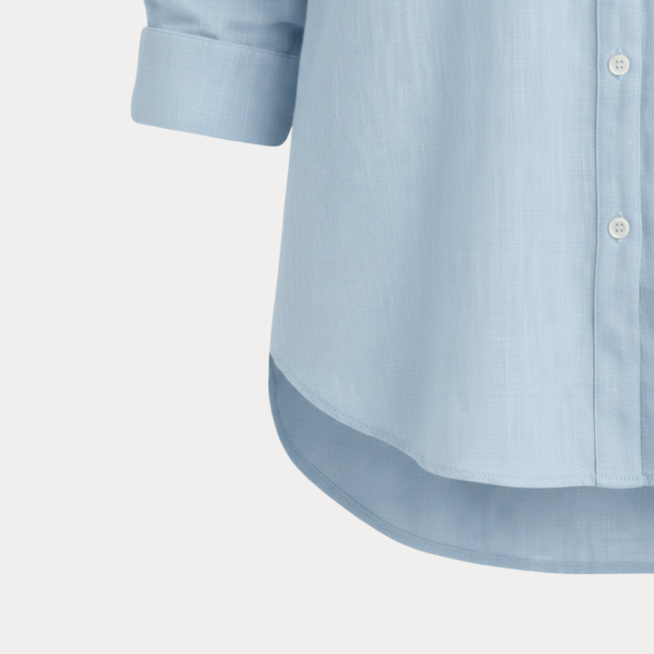 Fashionable women's blue button-up shirt, a long-sleeve classic for elegant office or casual style.