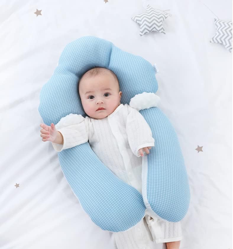 Parents gently placing a baby into the soft cotton ergonomic cuddle nest for sleep.