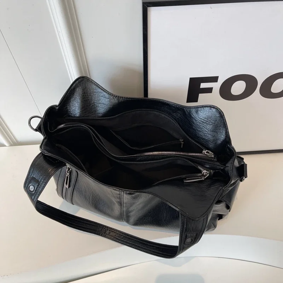 Interior view of a vegan leather women's shoulder bag, organised compartments