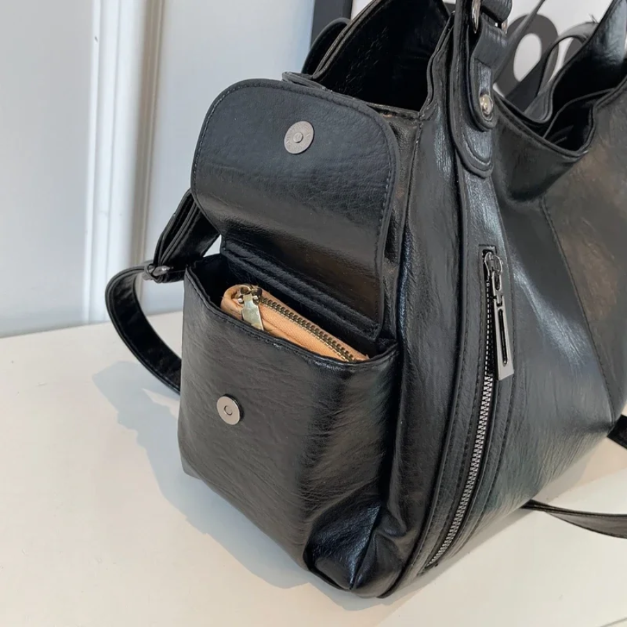 Front view of a black vegan leather women's shoulder bag, minimalist and elegant