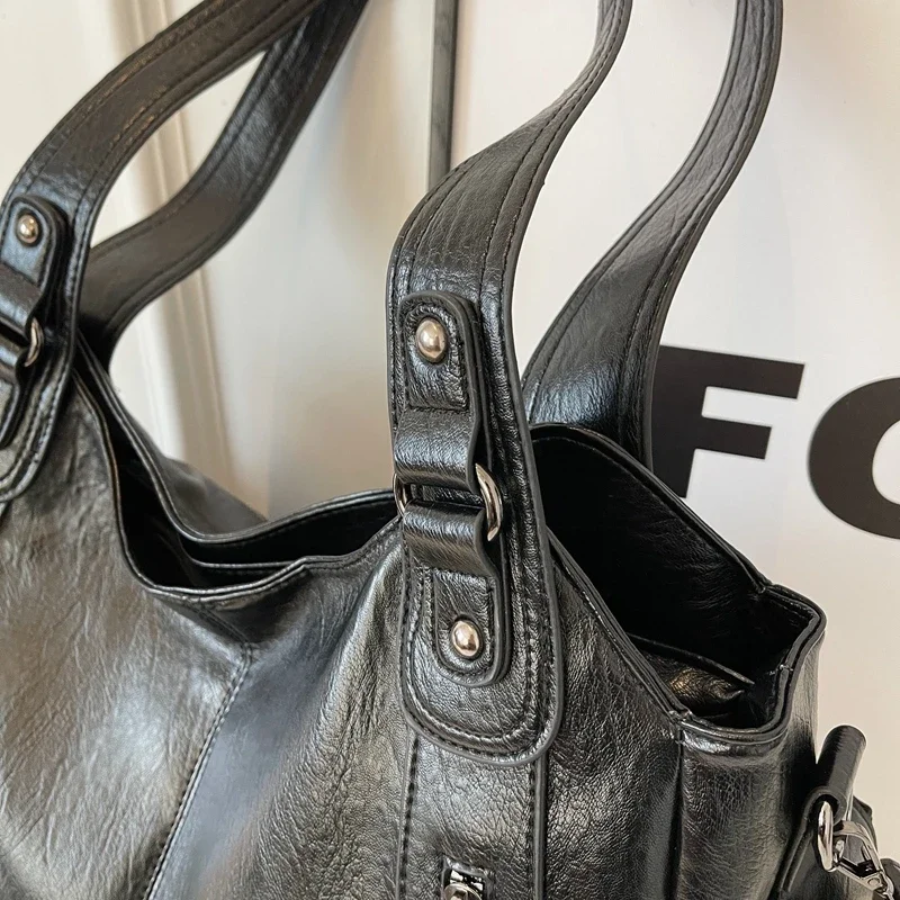 Model wearing a cognac vegan leather shoulder bag, showcasing its casual style