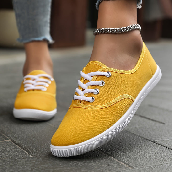 Versatile women's low-top canvas shoes with lace-up closure for casual, comfortable footwear.