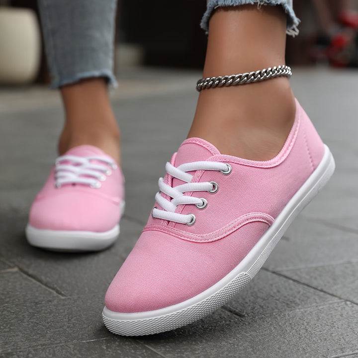 Lightweight women's low-top canvas lace-up sneakers, comfortable for daily wear.