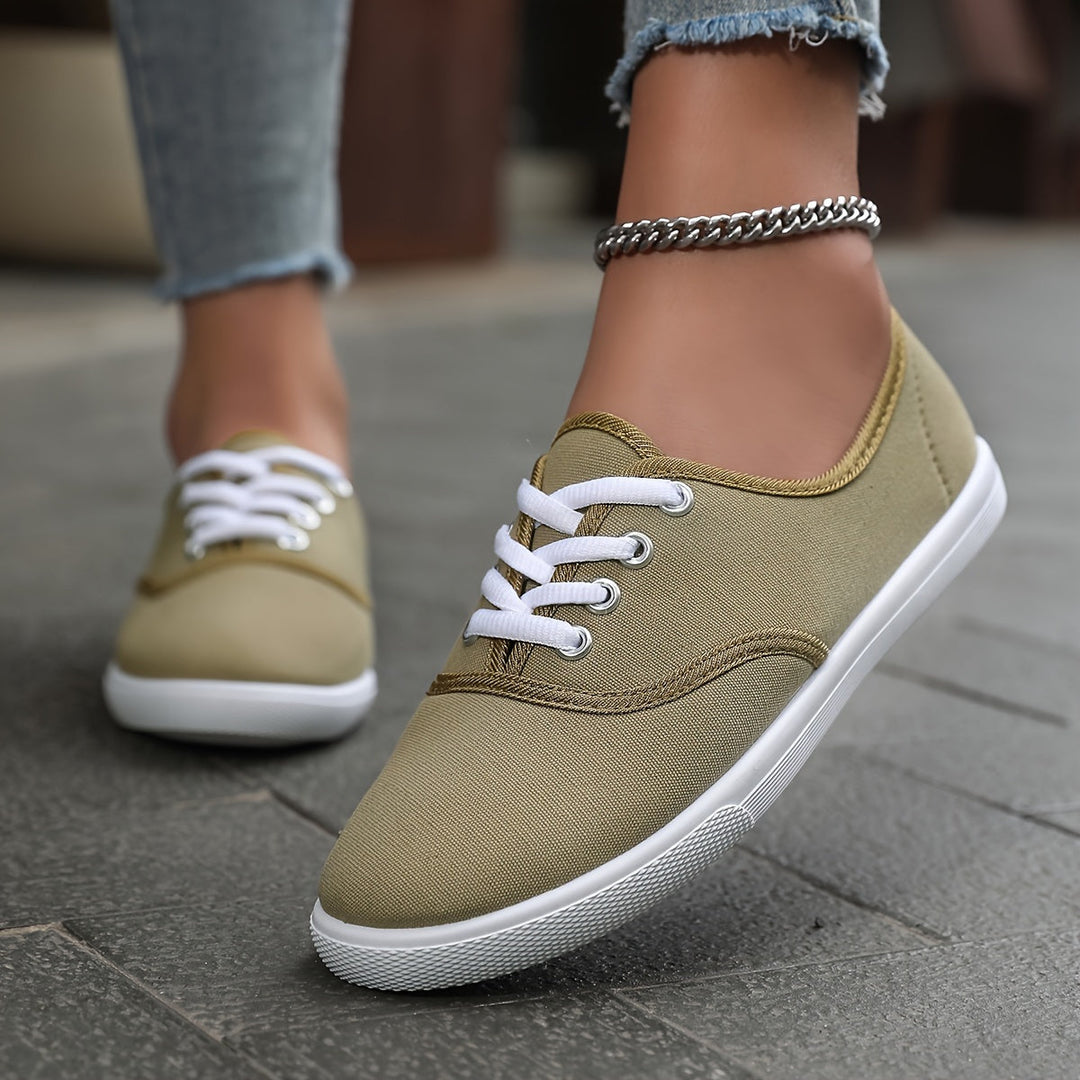 Low-top canvas lace-up sneakers for women, designed for comfortable everyday footwear.