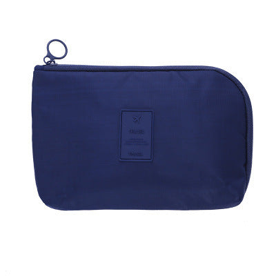 Waterproof tech pouch for travel, featuring compact design & organized cable storage.